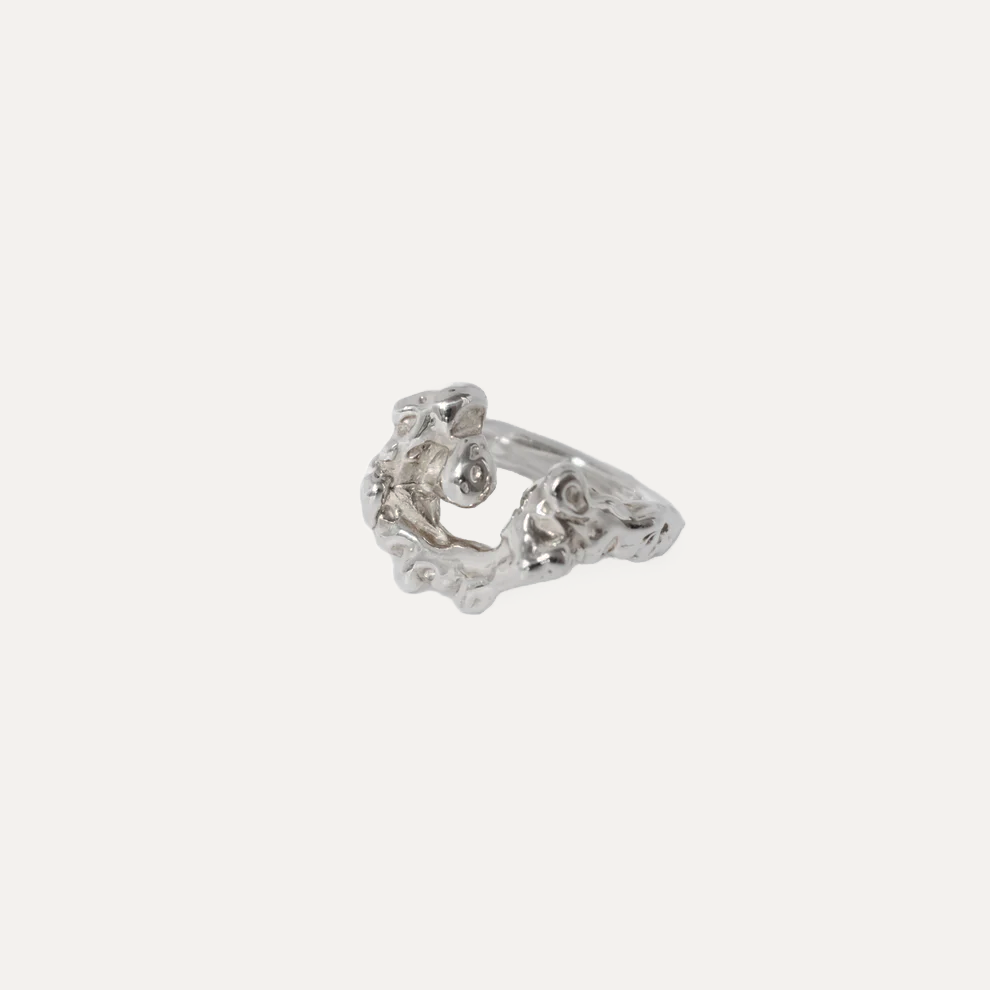 A sterling silver ring with a textured design, inspired by the waves hitting the rocks and foaming upwards. Solid sterling silver ring.
