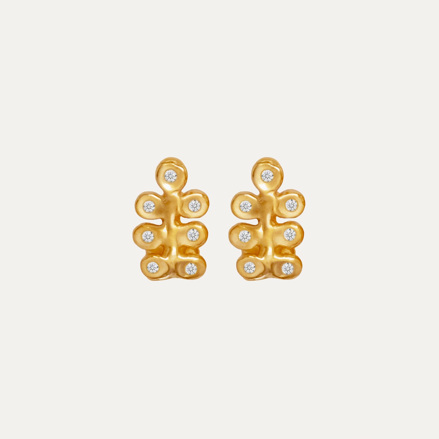A pair of gold earrings featuring an organic design with small gemstones.