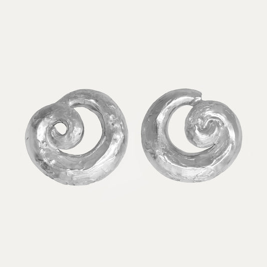 A pair of textured silver earrings with a spiral design.